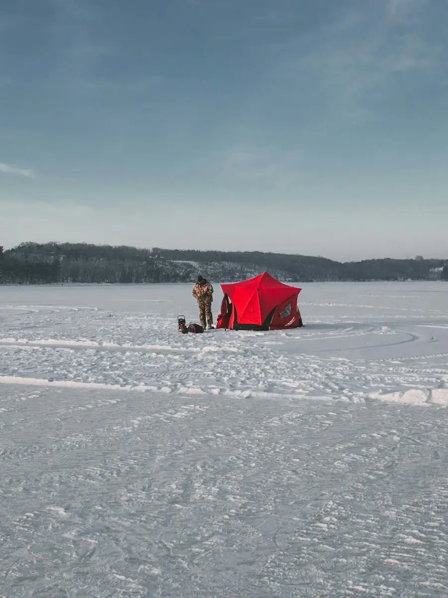 Alaska Outdoor Retreats – Man Ice Fishing by Red Tent